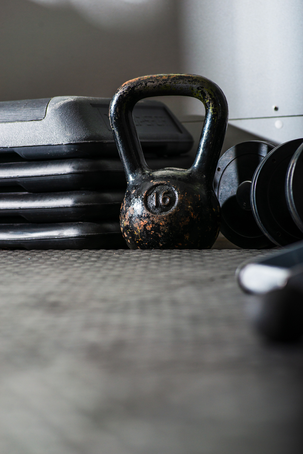 Kettle bell and dumbbells on floor in gym